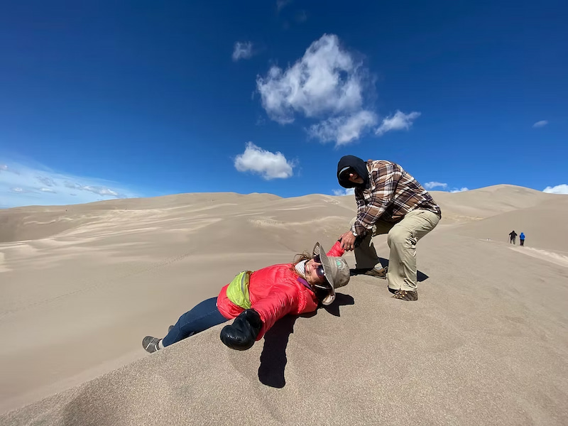 Helping my mom reach the top of the dunes in Great Sand Dunes National Park